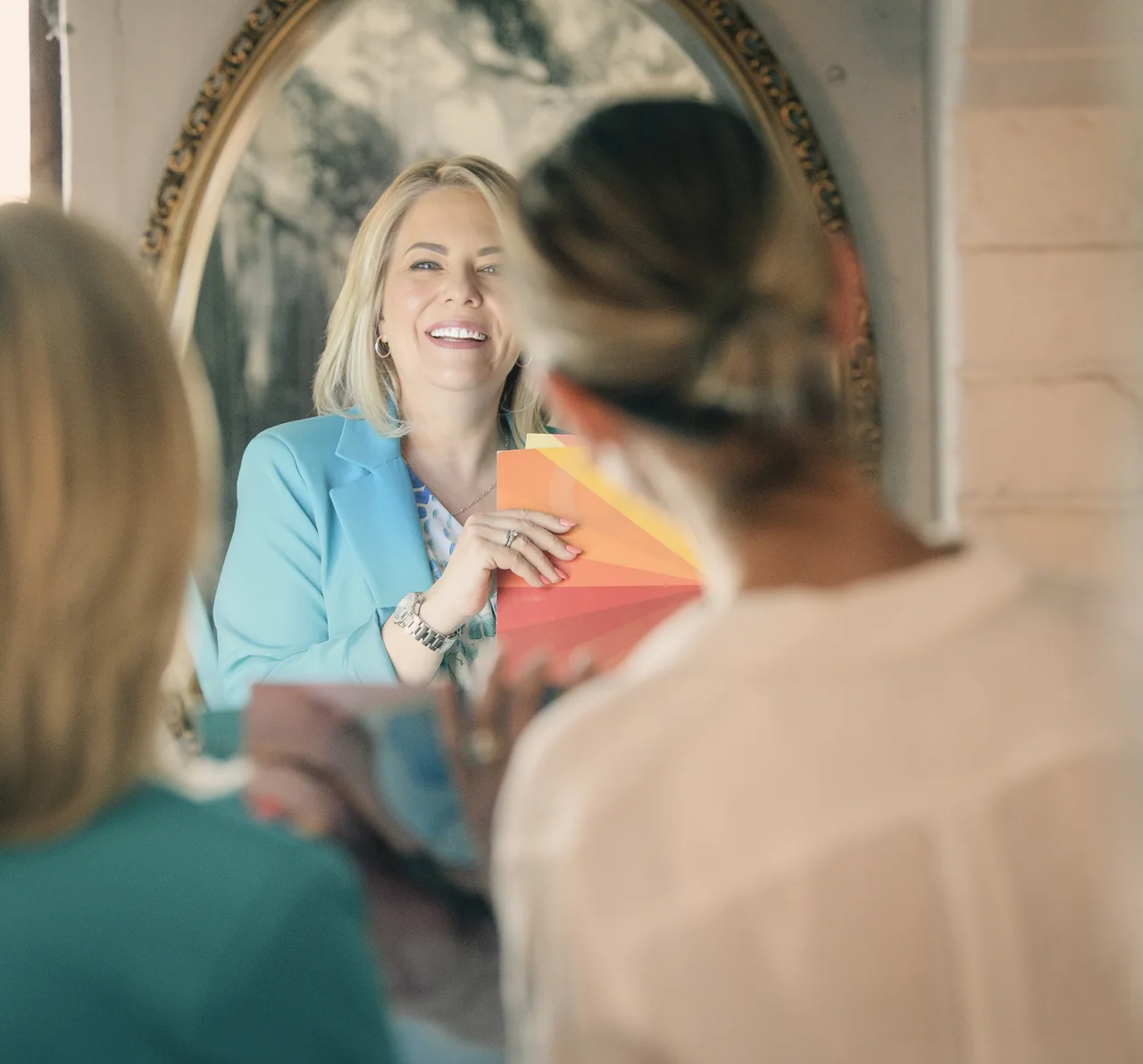 Helga Jackson working with a client and colour swatches